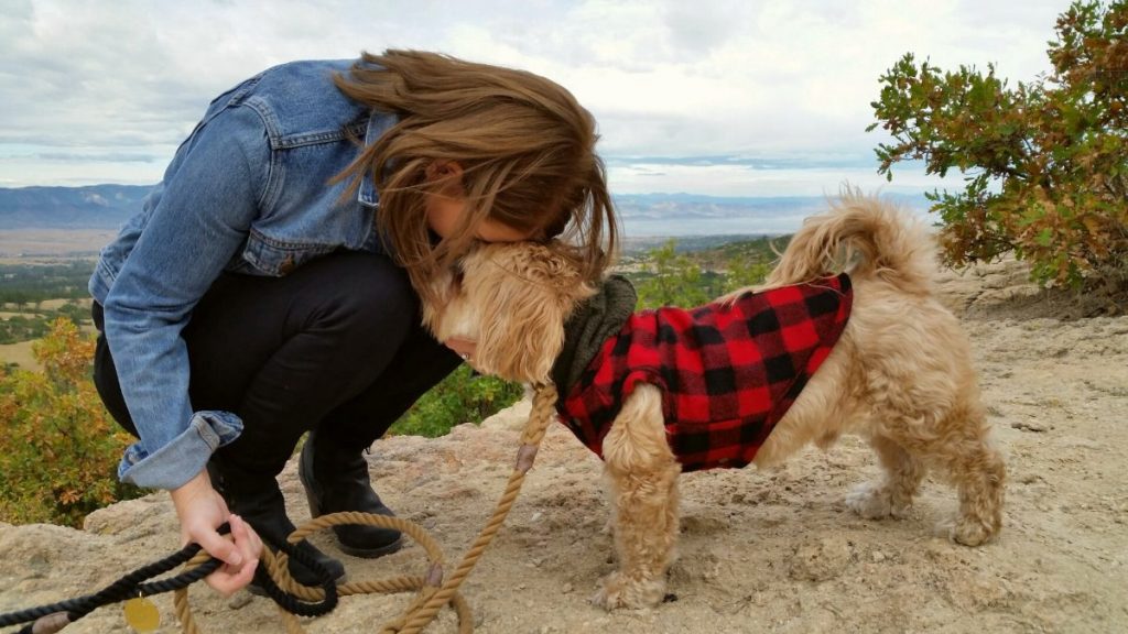 woman snuggling with her trained emotional support animal dog